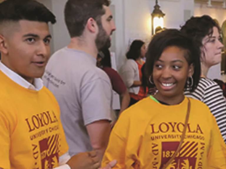 Two smiling students wearing LOYOLA shirts