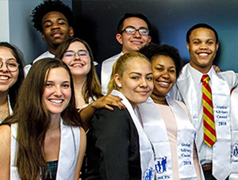 Eight students wearing sashes that say Student Advisory Council 2018