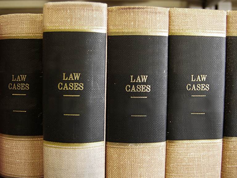 Four books with the words "Law Cases" printed on the binding