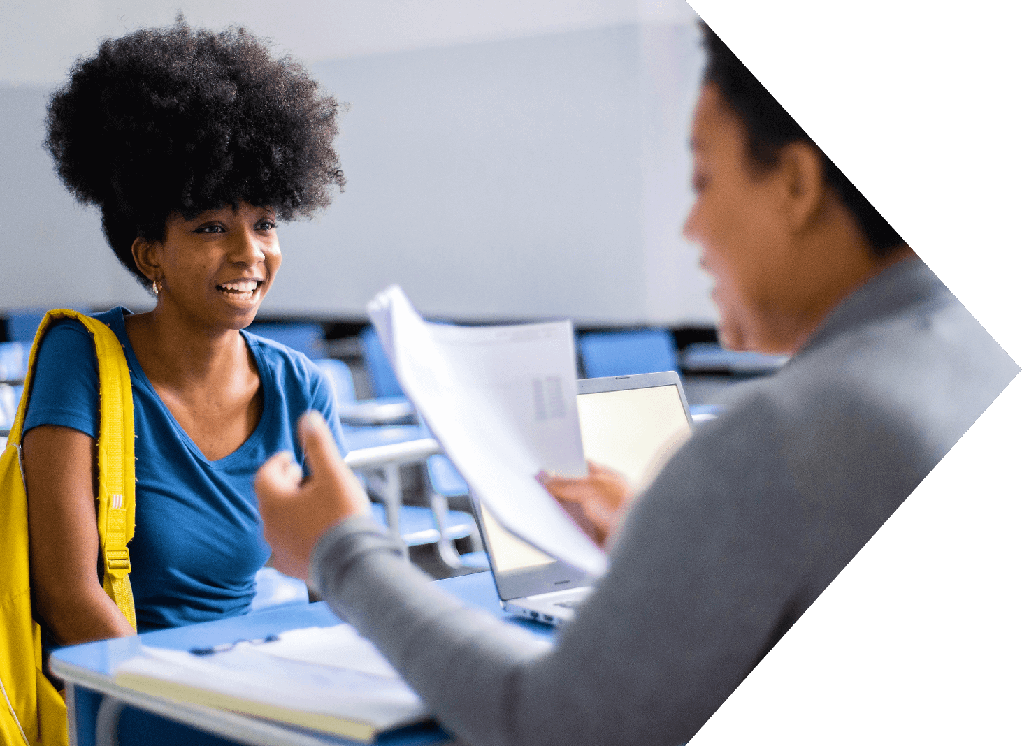 image of smiling student talking to teacher