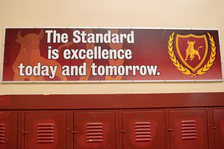 A sign stating "The standard is excellence today and tomorrow"