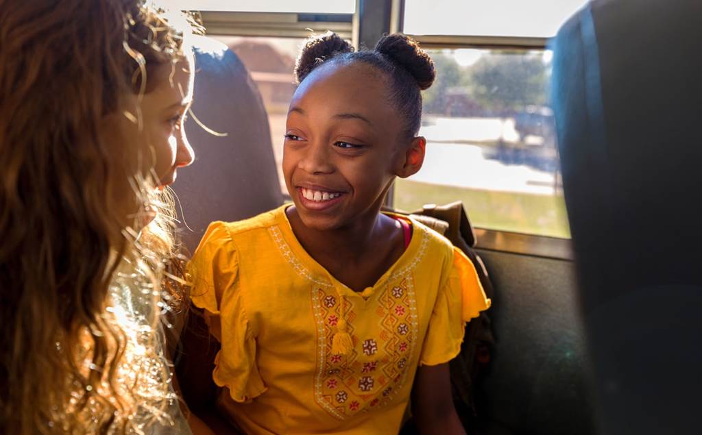 two students talking on school bus