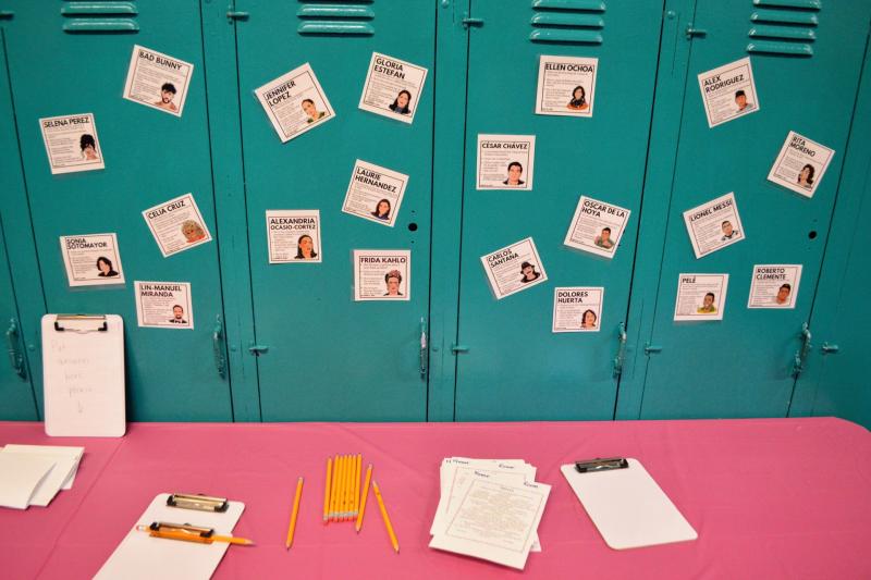 table covered in a pink cloth, adorned with lockers displaying pictures