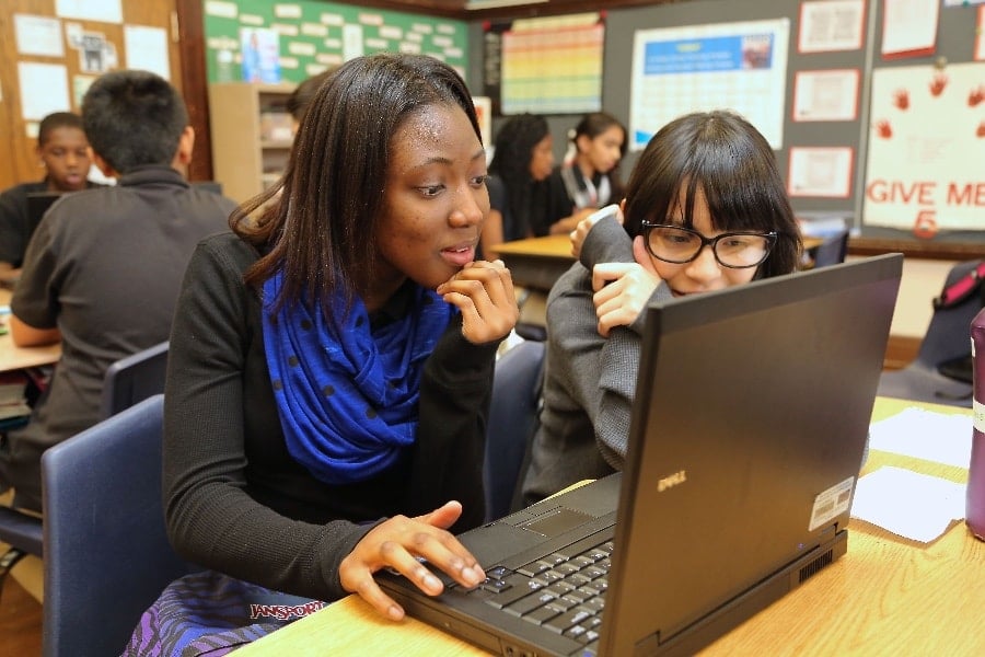 Two students sharing a laptop