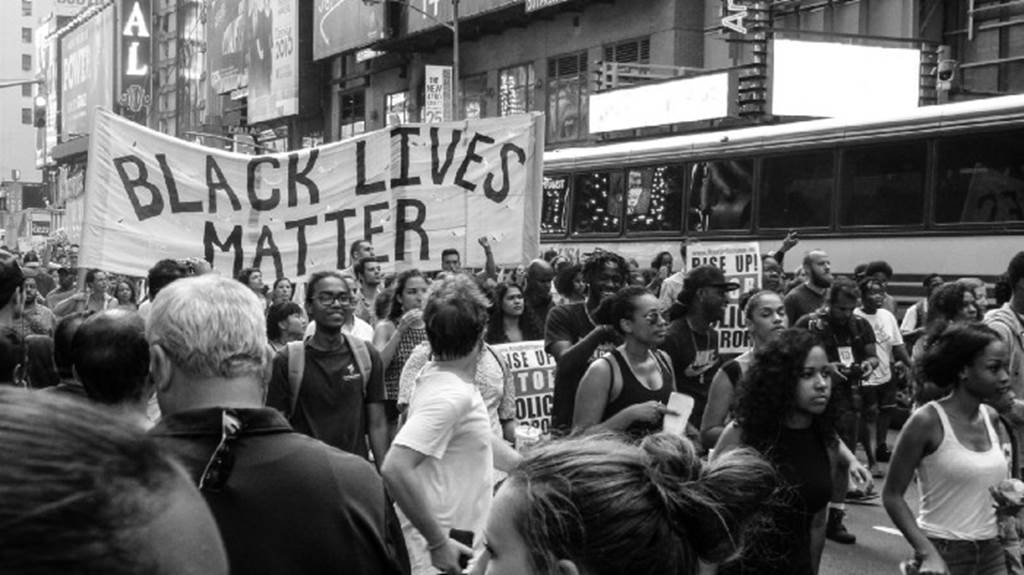 Group of protesters holding a Black Lives Matter banner