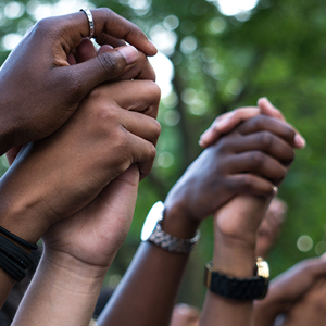 image of hands raised together