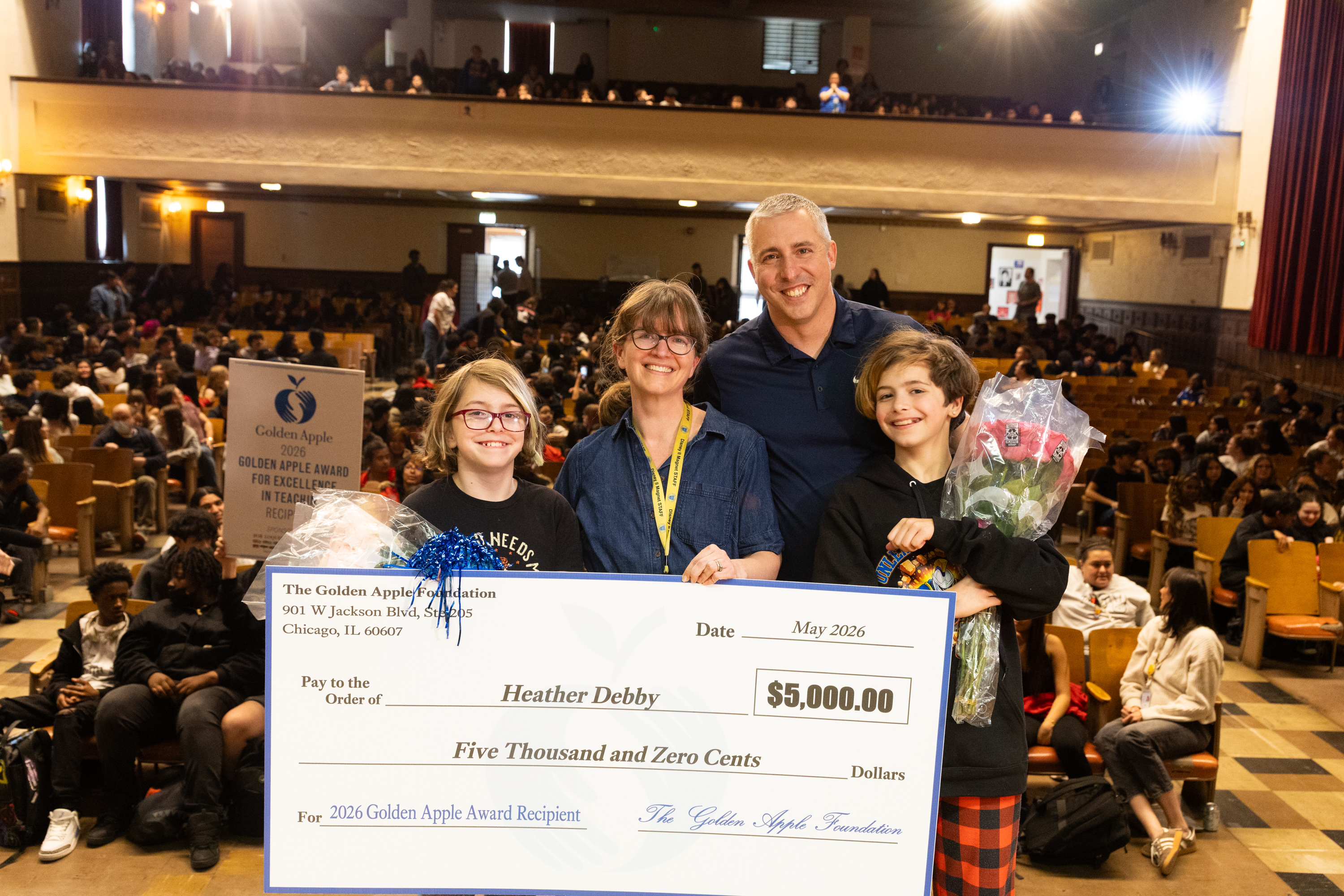 Ms. Debby and her family at her Golden Apple Award celebration