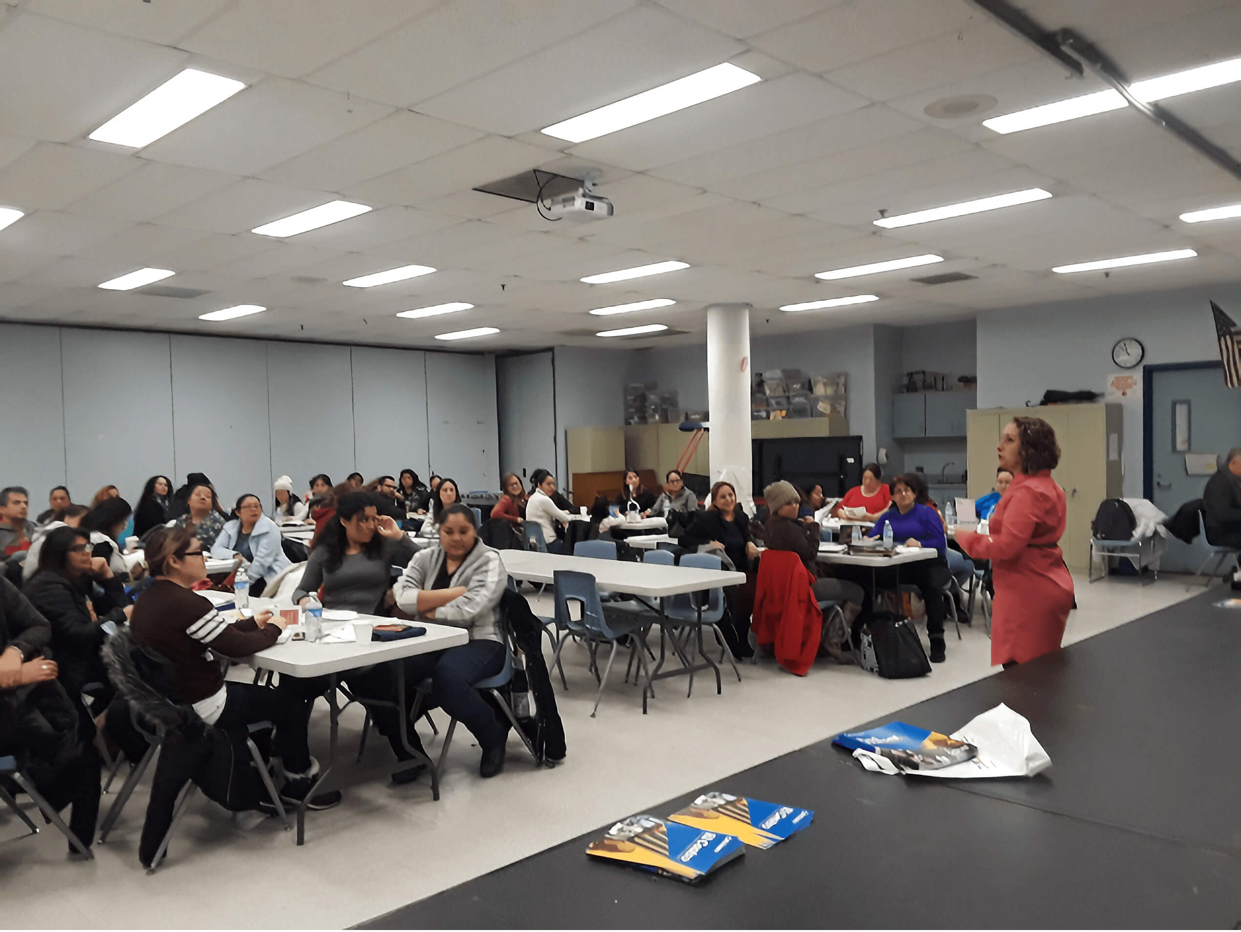 image of woman speaking to a room full of people