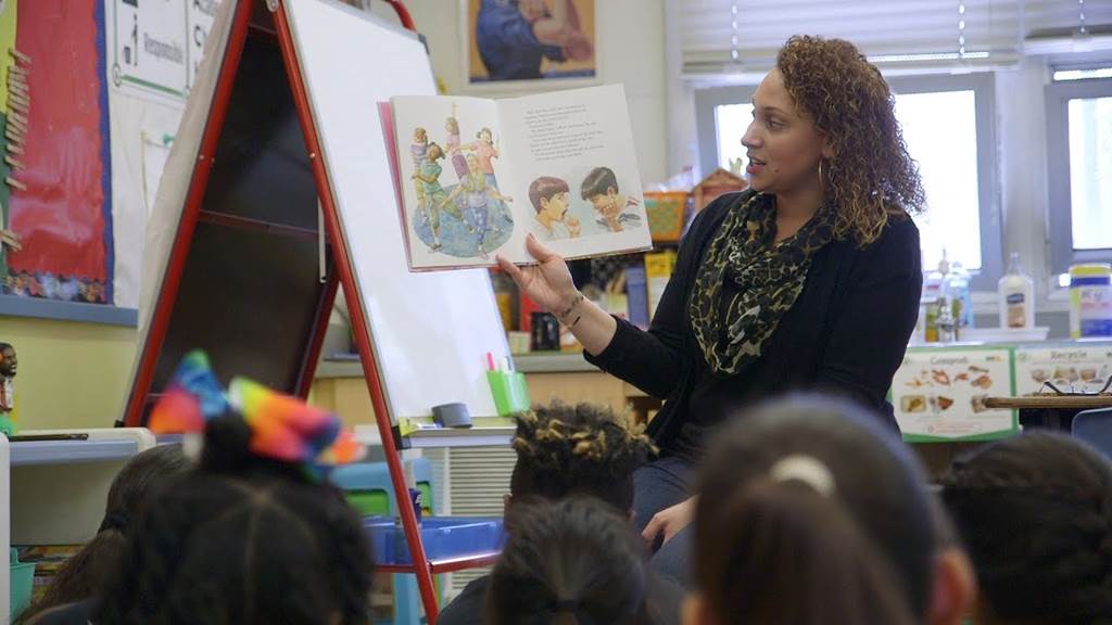 Teacher reading story to school children