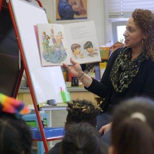 Teacher reading story to school children