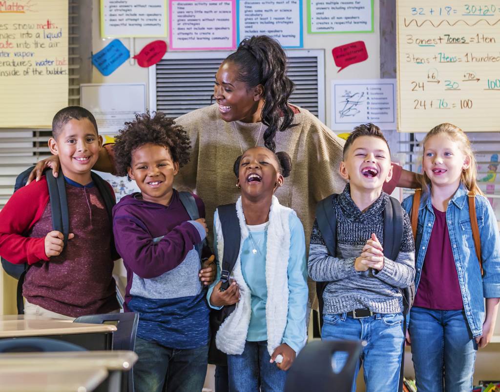 Teacher posing with 5 students