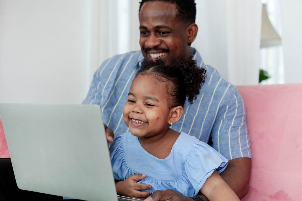 Parent and child exploring preschool options online