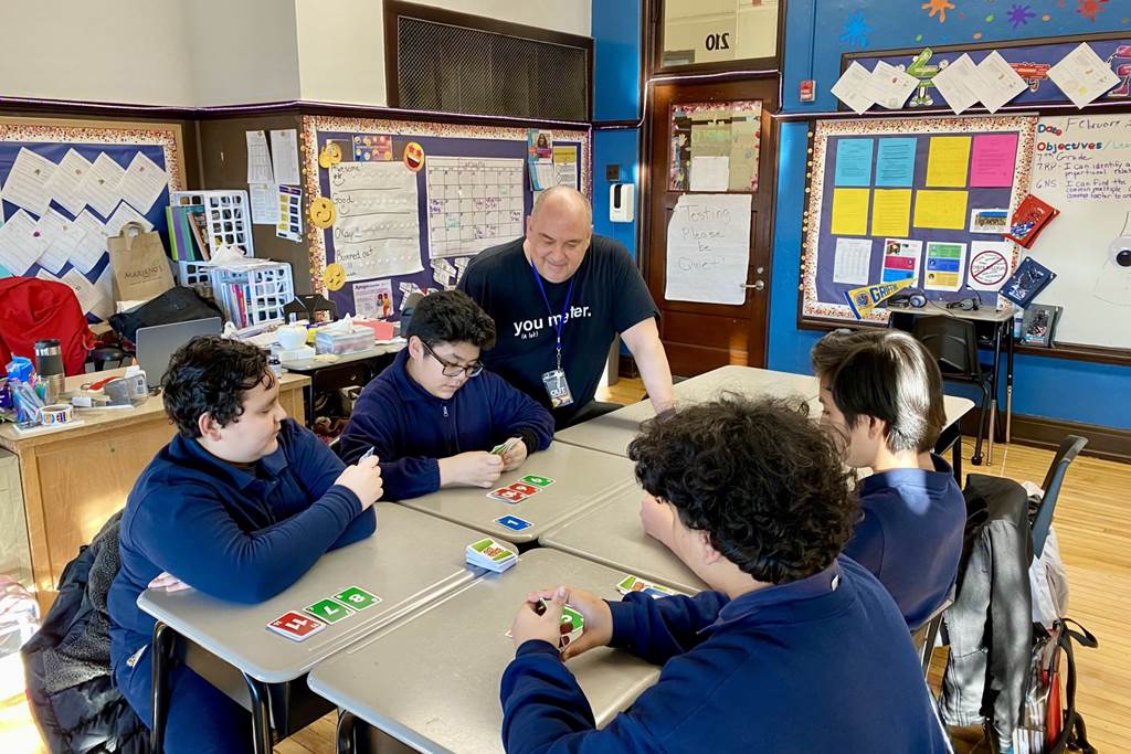 Students at Gary Elementary School play a card game