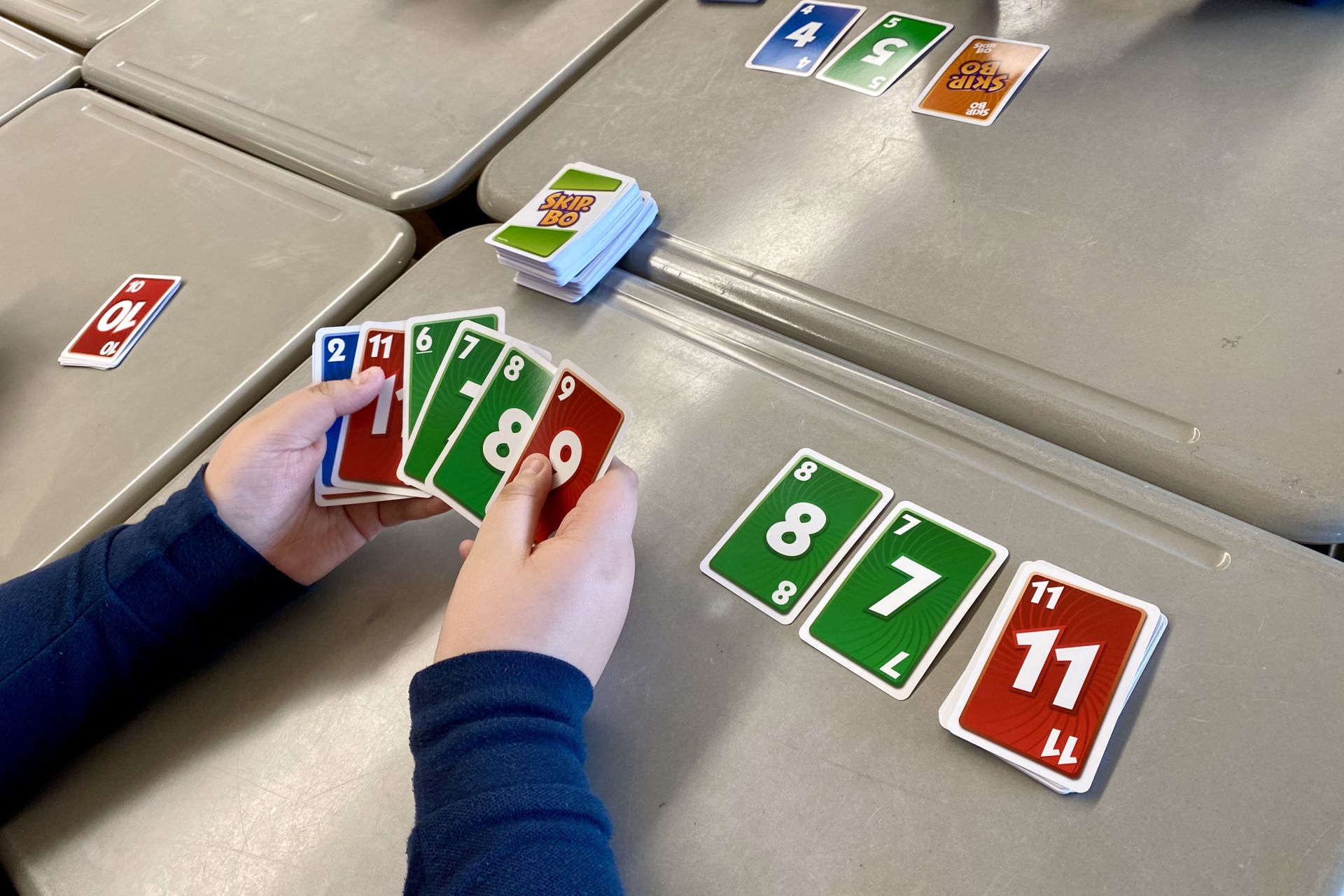 Close-up of student's hands holding cards