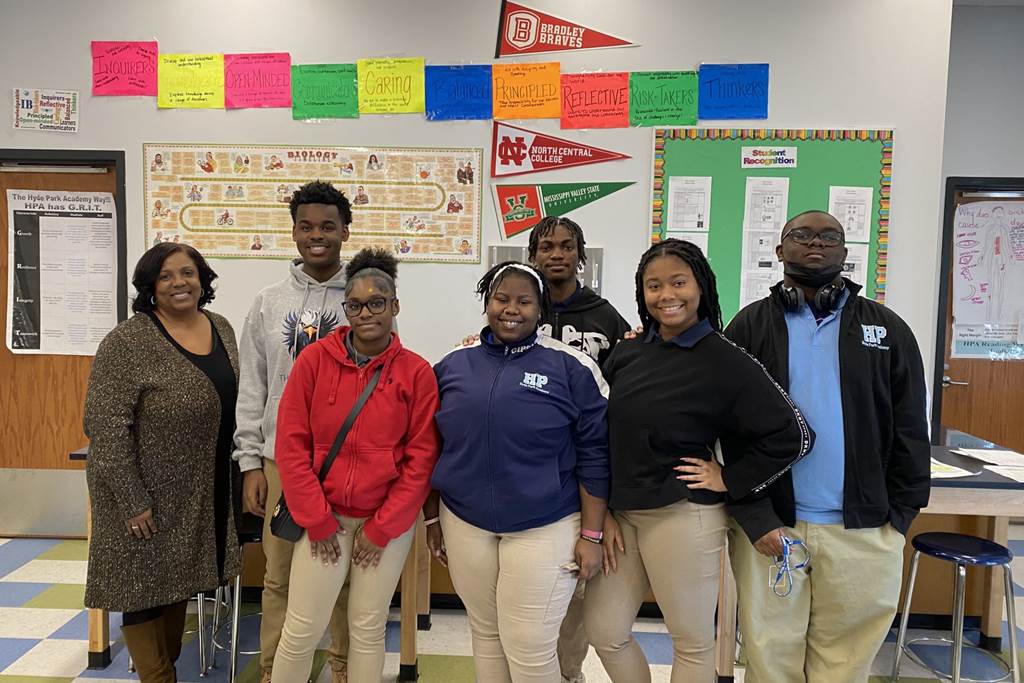 Six members of the Student Council Civics Club and their staff sponsor, Ms. Hill, pose for a photo inside of a classroom