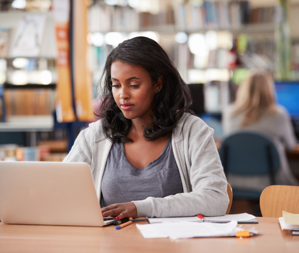 Woman studies for college courses in a library