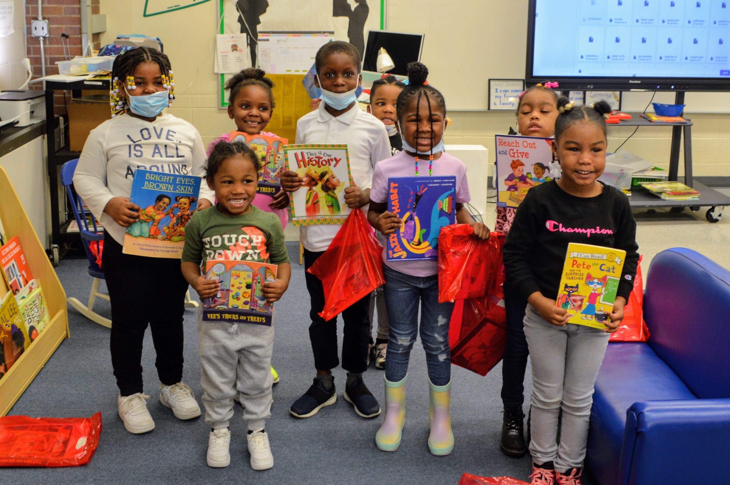 Group of young students holding books