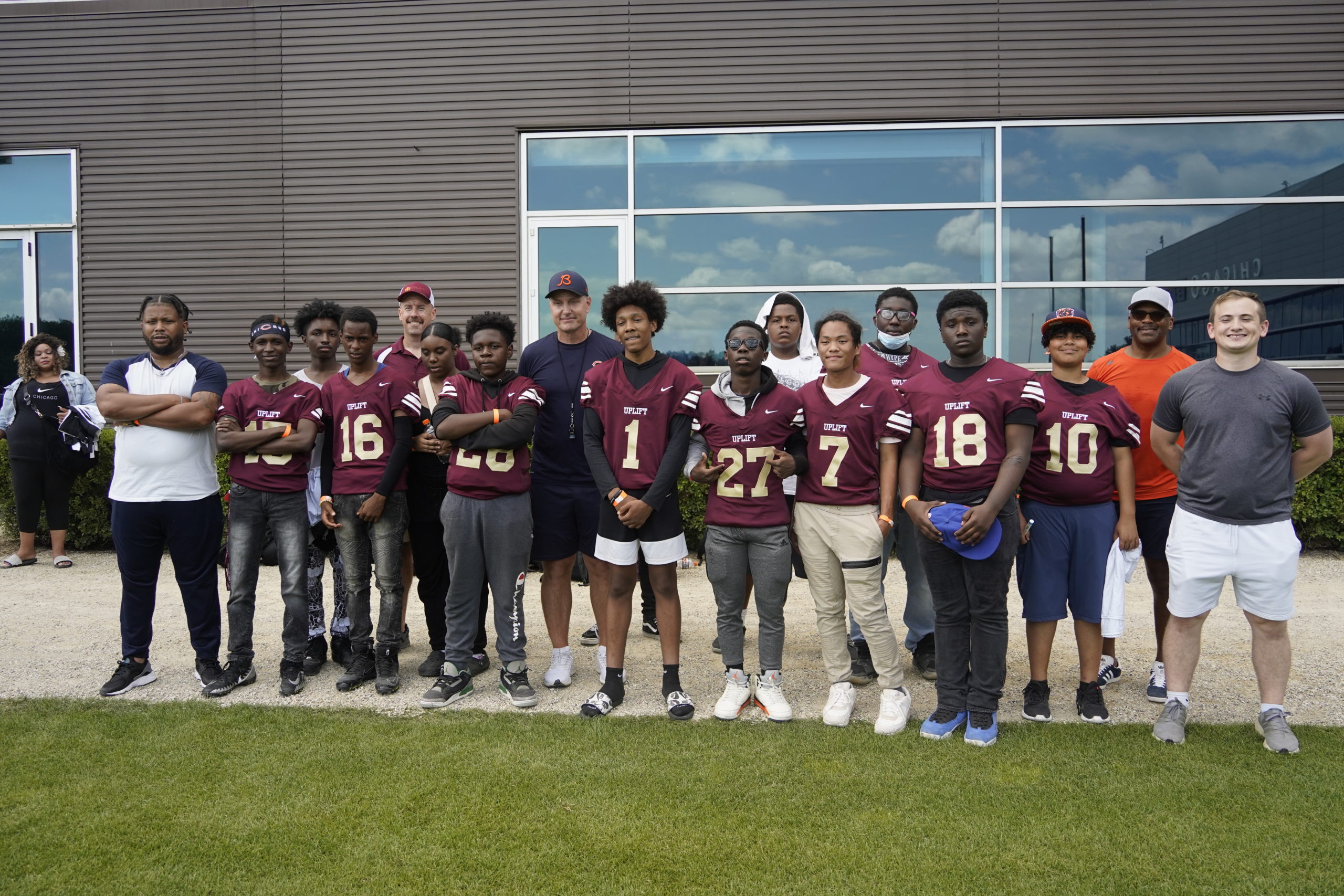 students posing with the coach