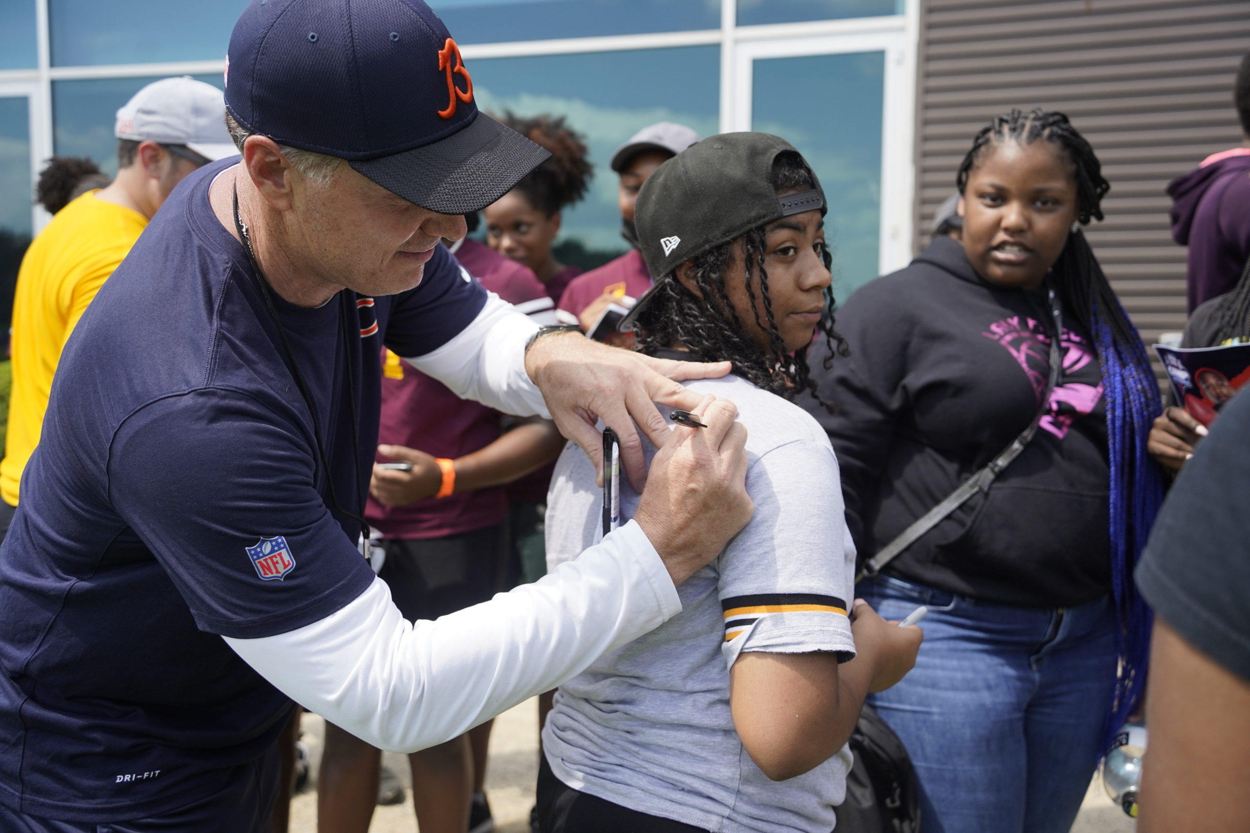 Matt Eberflus signing an autograph