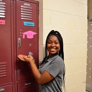 A photo of Saharia in front of her locker