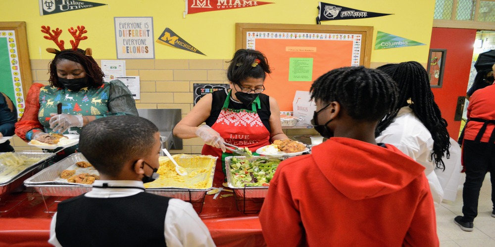 Staff and parents serving kids