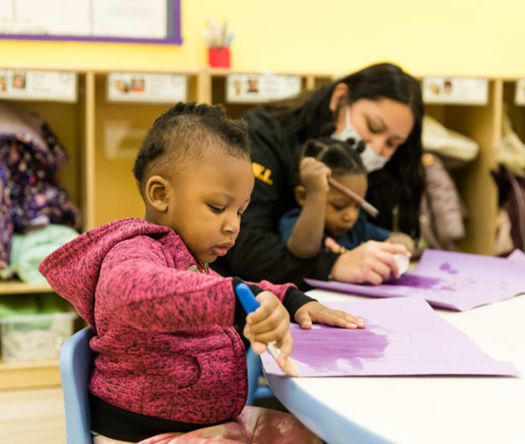 Child painting in Chicago Early Learning classroom