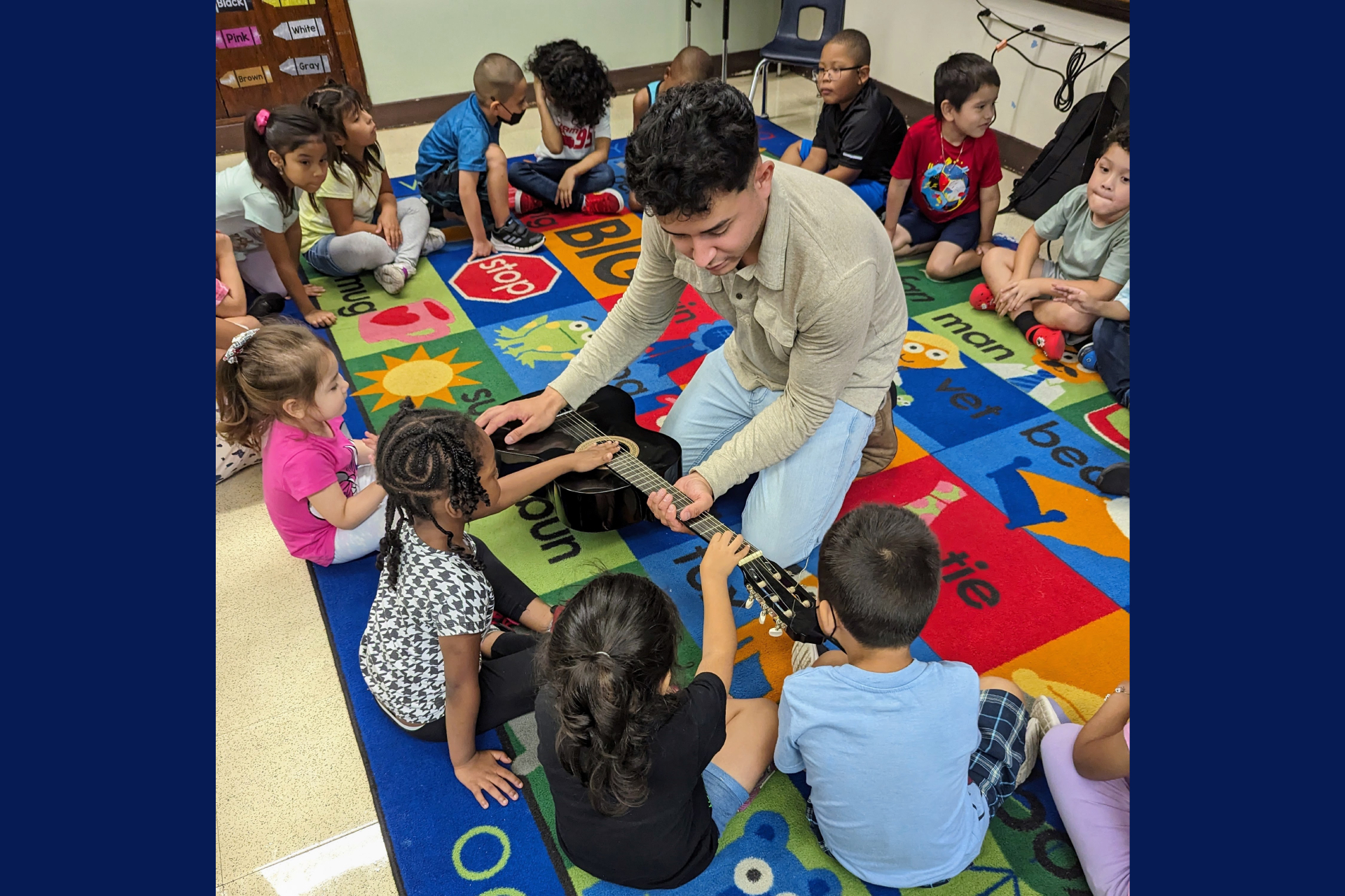 students seated on a carpet at Marquette School of Excellence