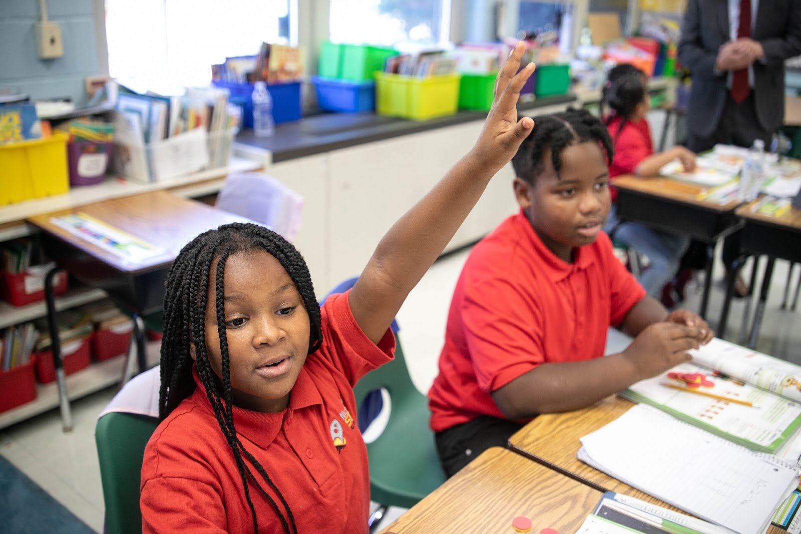Student raises their hand in class