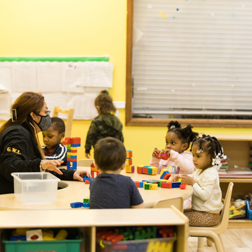 Students in Community-Based Preschool play together with blocks