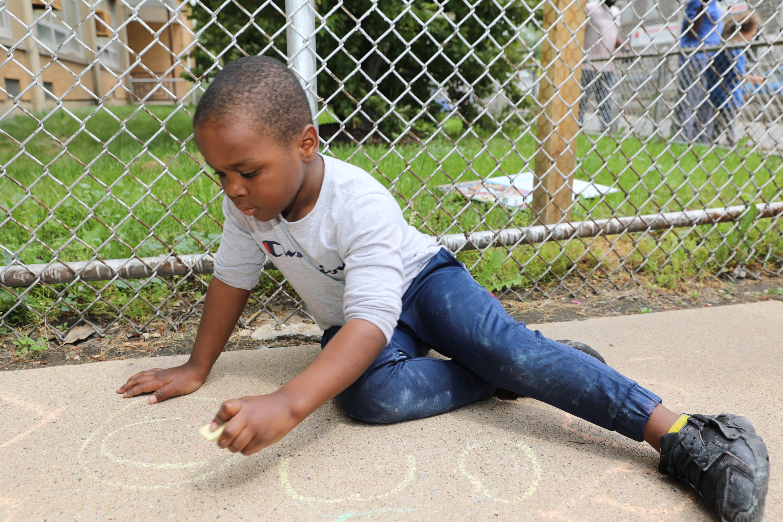 Kid drawing on sidewalk