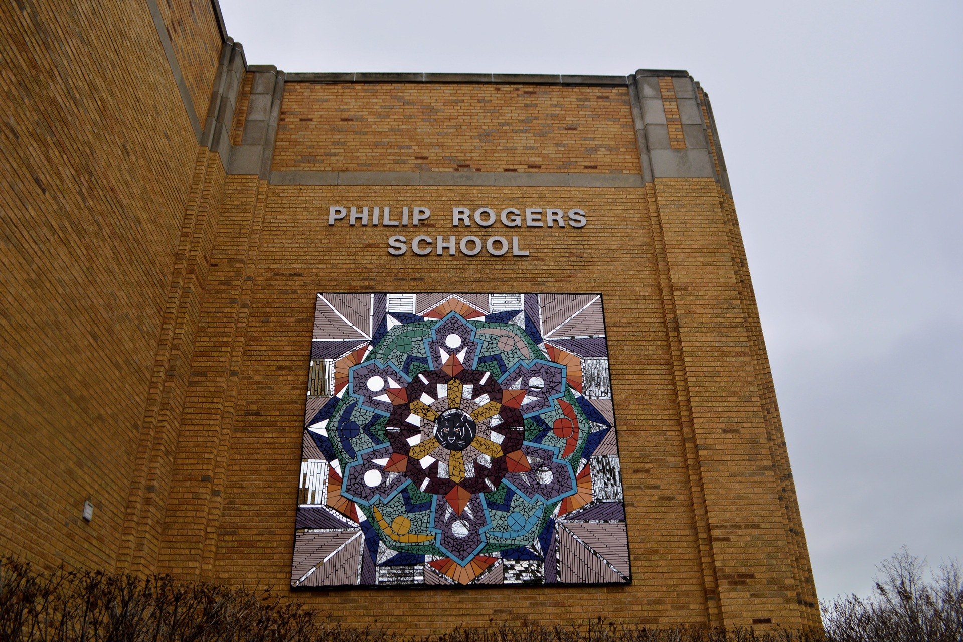 Philip Rogers School sign on top of a mural