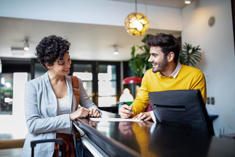image of people on opposite sides of a reception desk