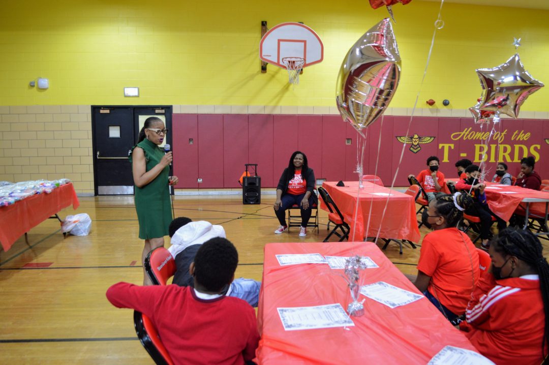 image of teacher speaking in gymnasium