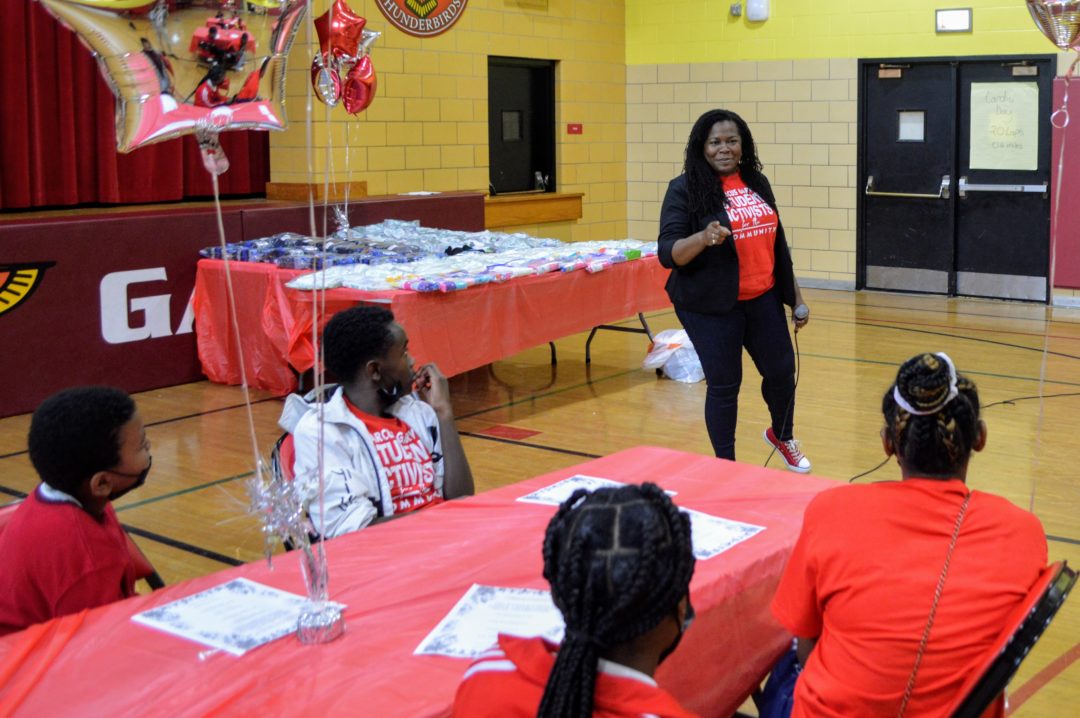 image of teacher speaking in gymnasium