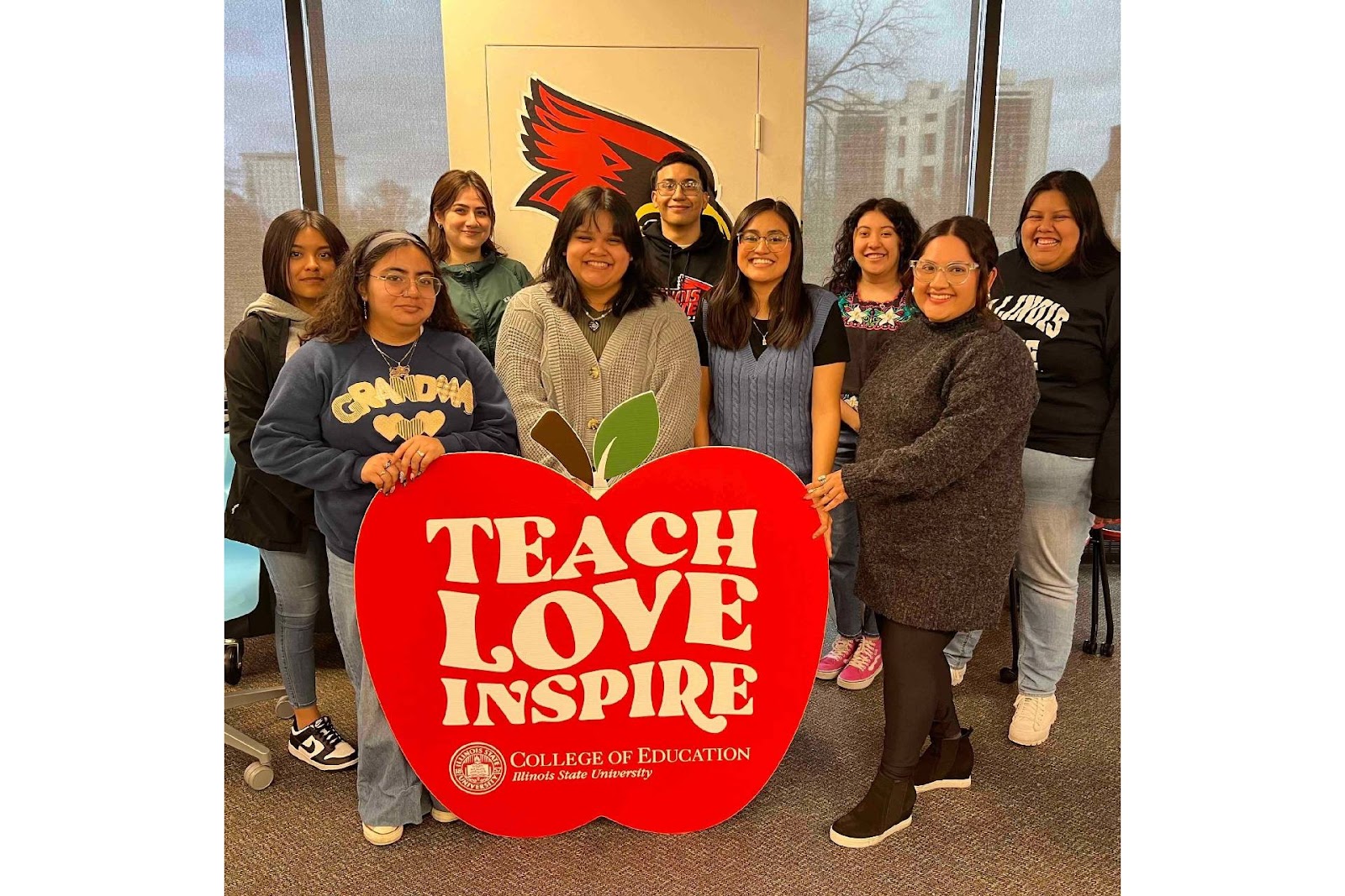 Group photo with teach, love, inspire banner