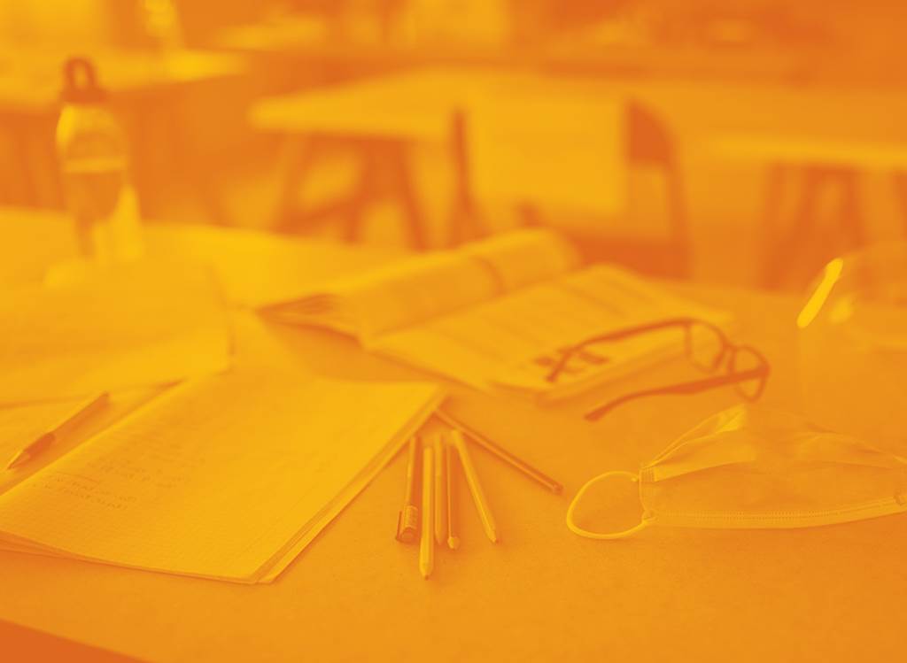 Image of supplies and a mask on a desk
