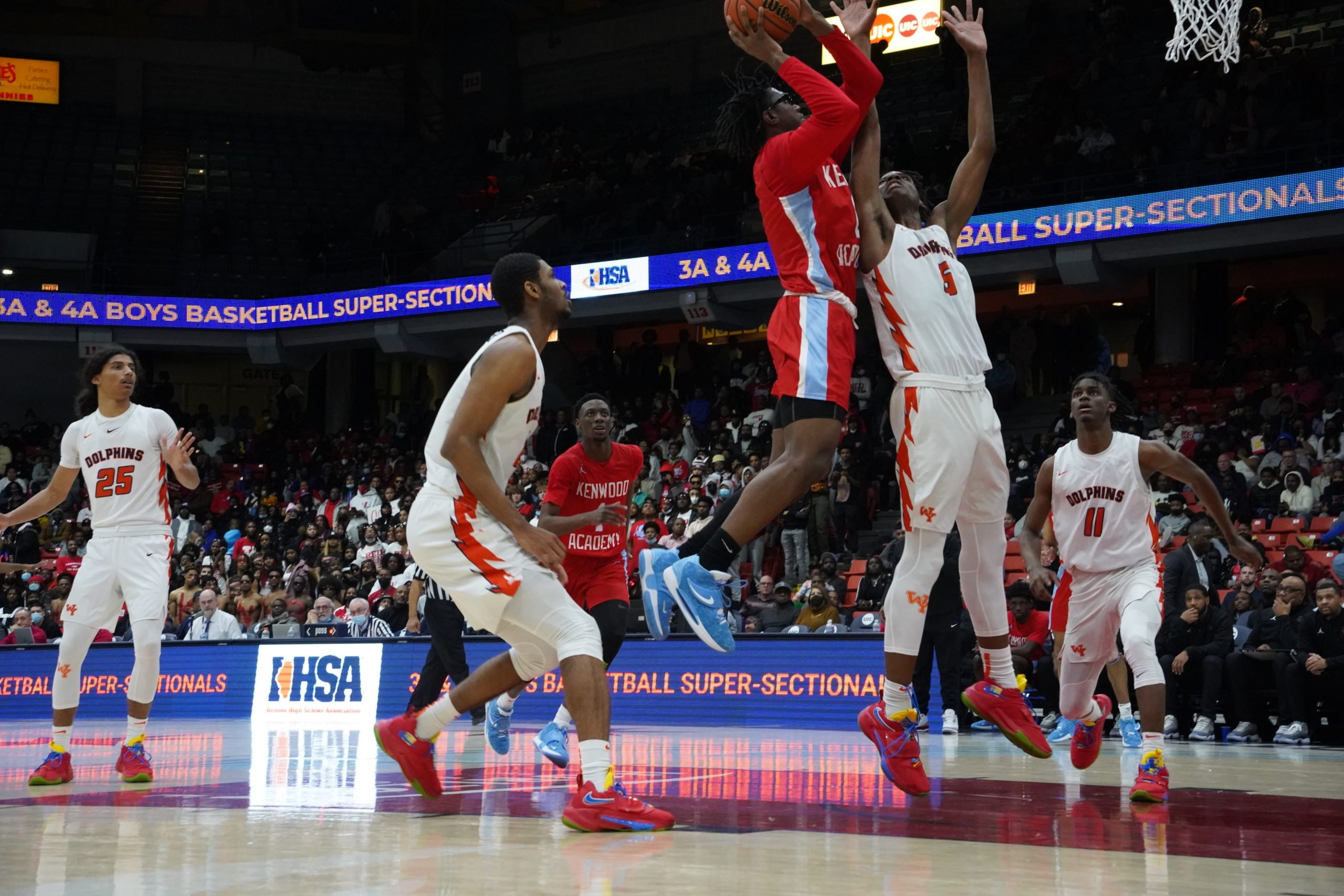 A Kenwood player shooting the ball into a hoop