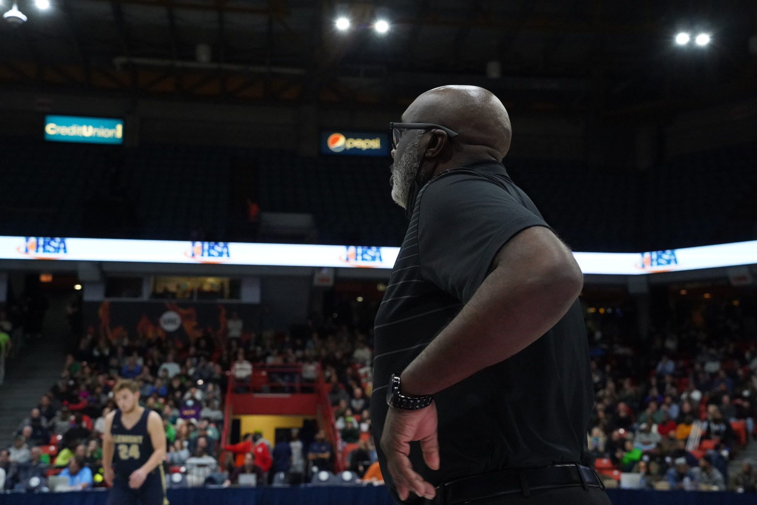 A man standing on a basket ball court