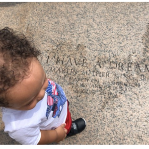 Self-Evident Truth image with child standing near 'I have a dream'