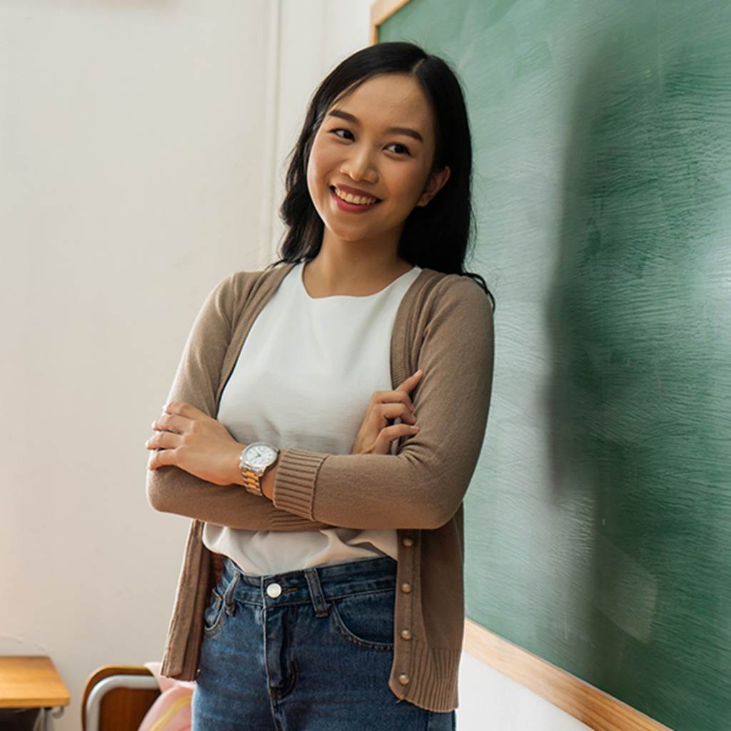 image of smiling teacher in classroom