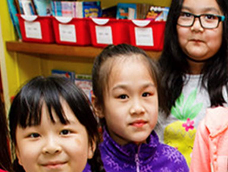 Three young girls smiling