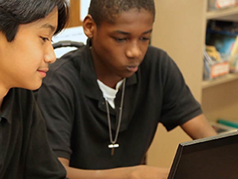 Two students looking at a computer screen