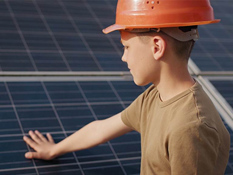 A student touches a solar panel