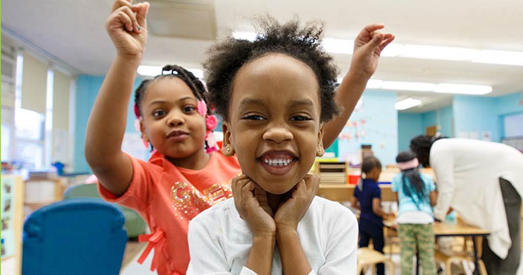 Young student playing with another student's hair