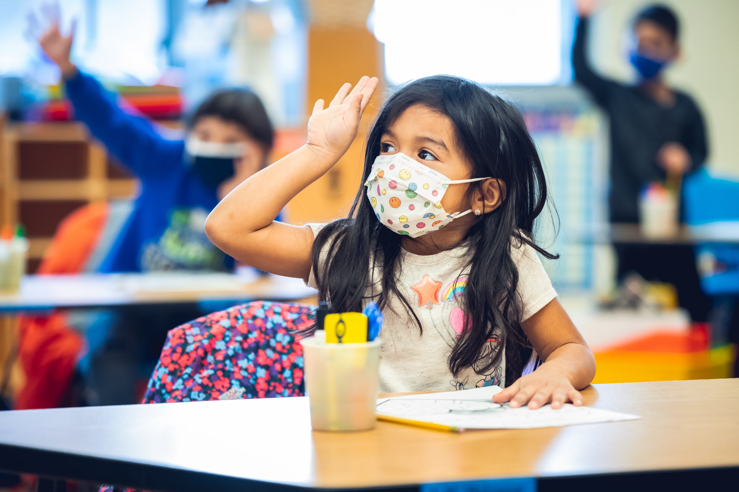 Student in class raising hand