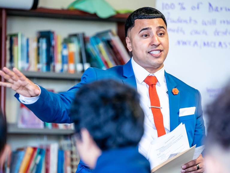 Man teaching a class full of students