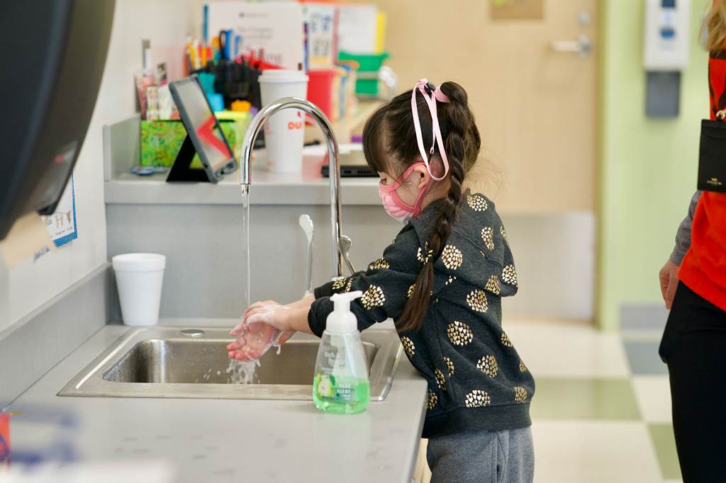 Young child washing hands