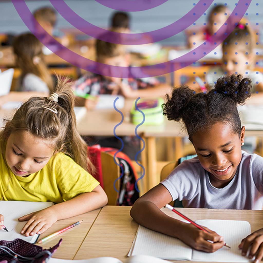 image of young students working at tables