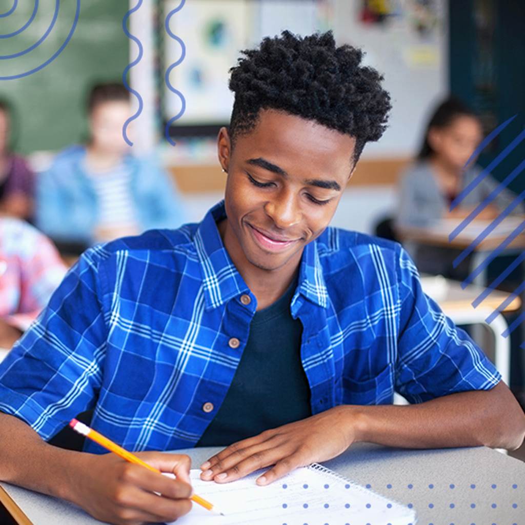 image of student writing at a desk