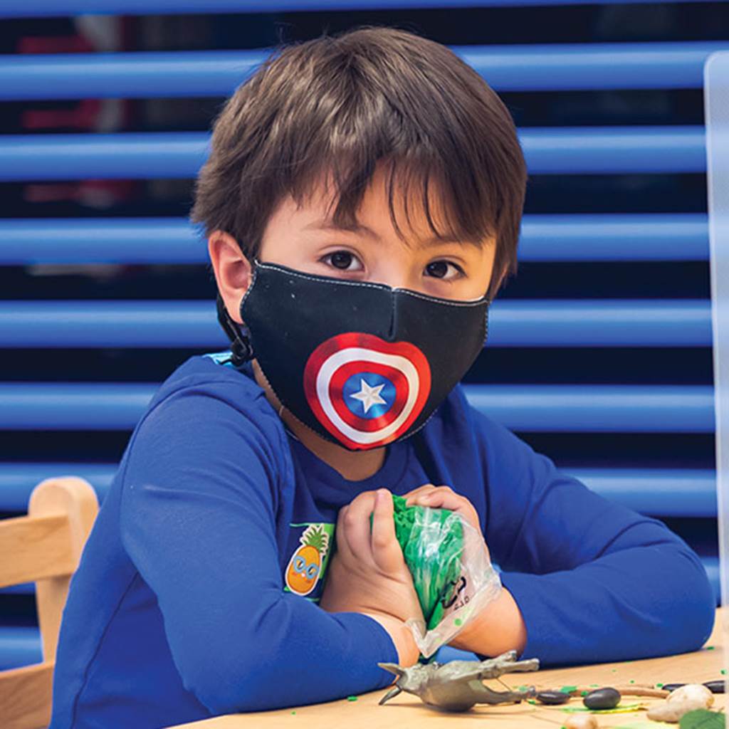 Image of a young student playing with clay